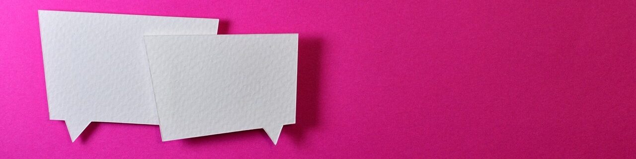 Two paper speech bubbles on a pink background