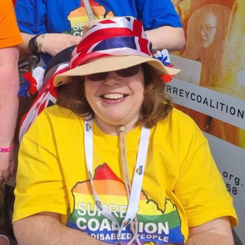 A staff member, Angie, wearing a bright Coalition t-shirt and a straw hat at the Cranleigh carnival