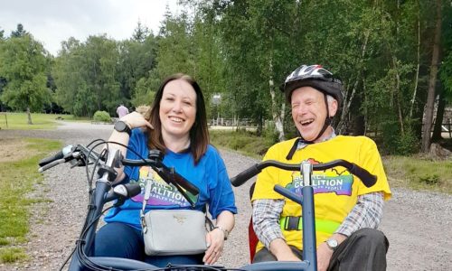 Two people enjoying themselves on a bike at Alice Holt Forest. This was a Get More Active Get Together