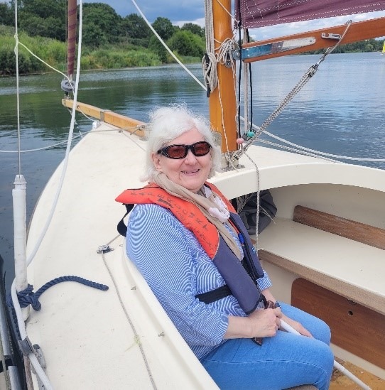 Photo of Jean smiling on a boat 