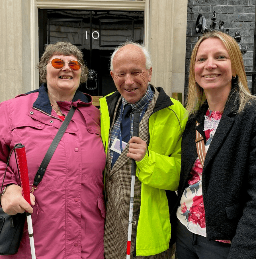 Jane, Jonathan and Nikki in front of the door at No.10 Downing Street.