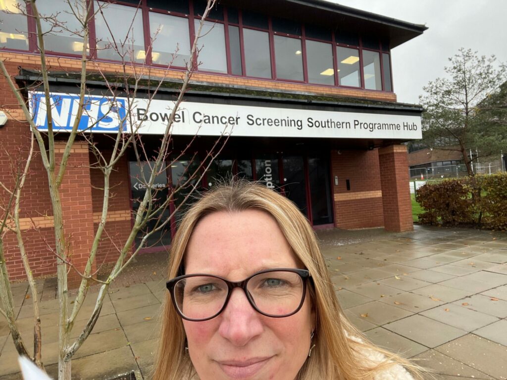 Photo of Nikki outside the Bowel Cancer Screening Southern Programme Hub 