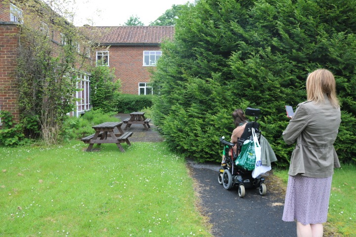 Image of Nikki and Is on a path at the Astolat office that is blocked by a large overgrown tree