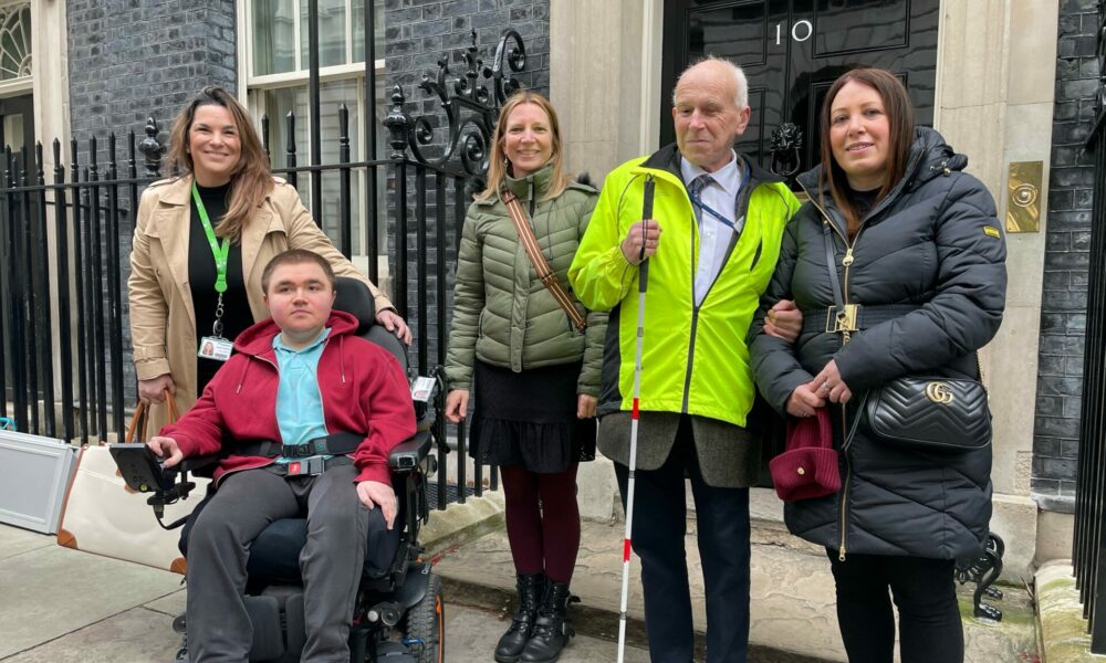 Photo of Yasmin, the Coalition's Involvement Lead, Nikki, the Coalition's CEO, Coalition member, Jonathan, and Ben and Karen from Treloar's outside the door at Number 10 Downing Street.